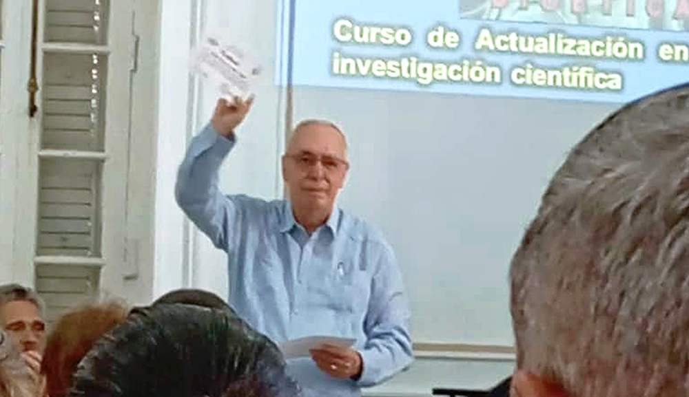 Dr. René Zamora presents recognition to the John Paul II Institute of Bioethics